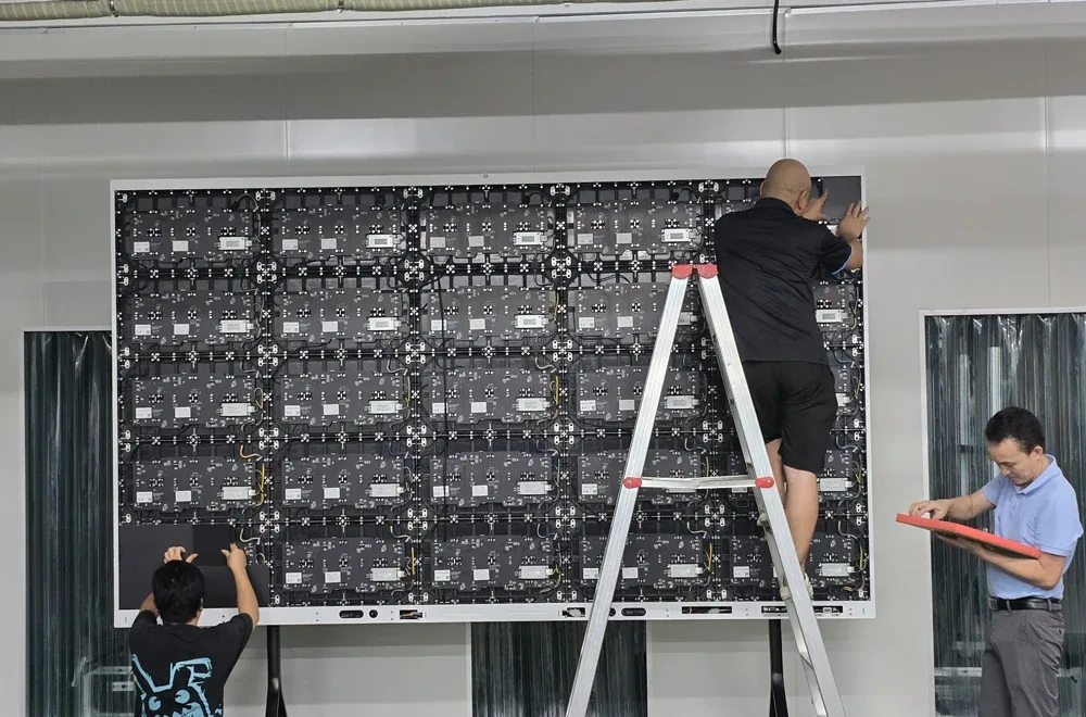Technicians assembling the cabinet frame and connecting cabling